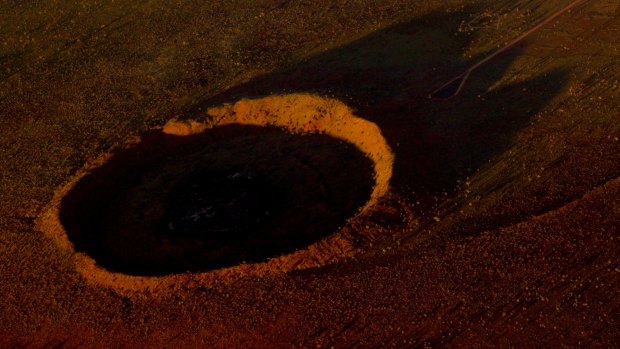 The Wolfe Creek meteorite crater looks spectacular in the setting sun.