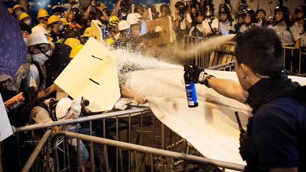 Confrontation: Pro-democracy protesters clash with police outside Hong Kong's government complex.