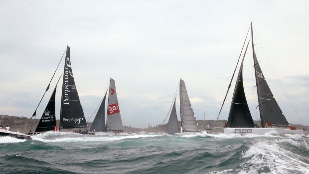Wild Oats XI, left, Ragamuffin 100 and Rambler, right, race past the first mark at the start of the annual Sydney Hobart yacht race in Sydney.