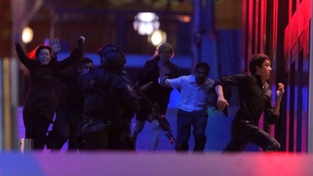 Hostages run from the Lindt cafe on the night of the siege.