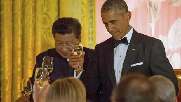 Chinese President Xi Jinping and US President Barack Obama toast at the White House state dinner on Friday.