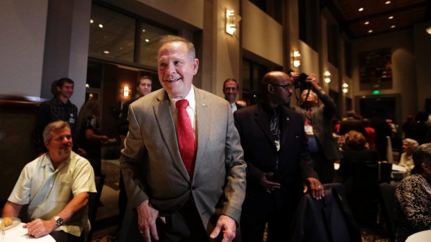 Former Alabama Chief Justice and US Senate candidate Roy Moore greets supporters before his election party.