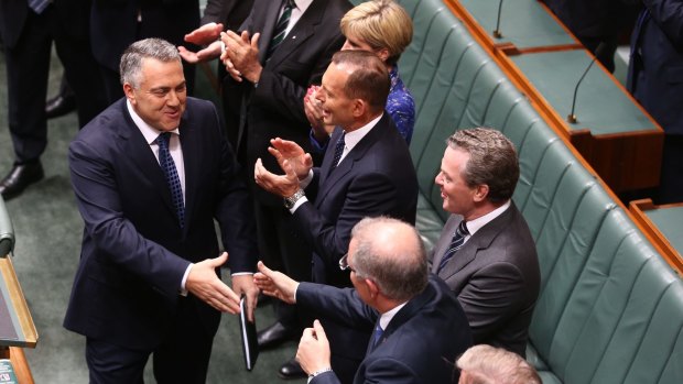 Treasurer Joe Hockey is congratulated by Social Services Minister Scott Morrison after his second budget to Parliament, in Canberra on Tuesday.