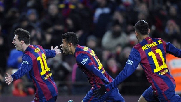 Barcelona's Lionel Messi celebrates with his teammates Rafinha and Neymar.