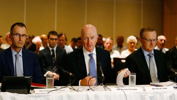 Glenn Stevens (centre) speaks at the House of Representatives Standing Committee on Economics.