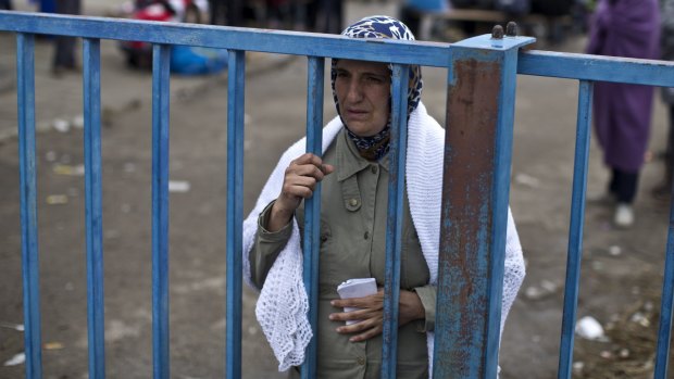 A woman looks for members of her family at a refugee reception centre in Opatovac, Croatia.