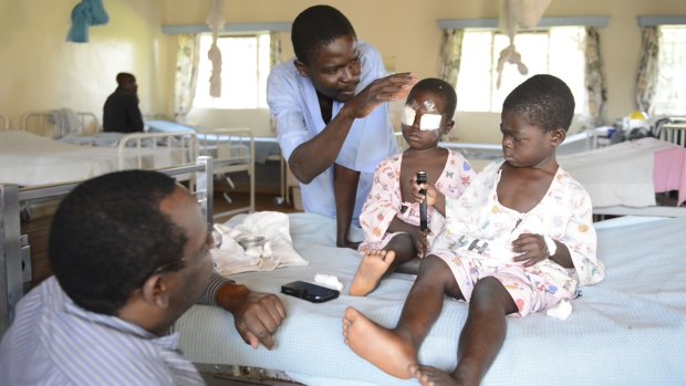 Kenyan children George, 4, and Alice, 5, after an operation to remove cataracts.