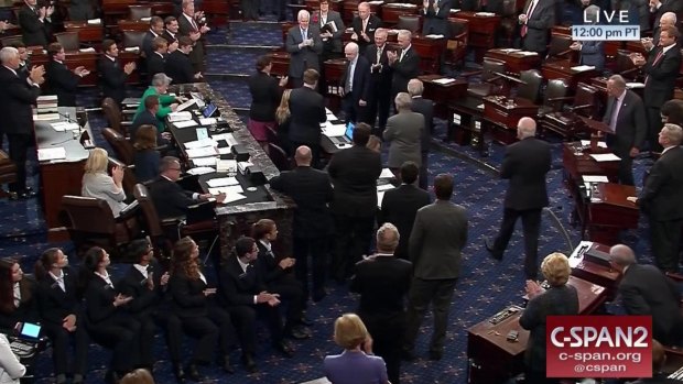 Senator John McCain is applauded as he arrives of the floor of the Senate on Capitol Hill in Washington.