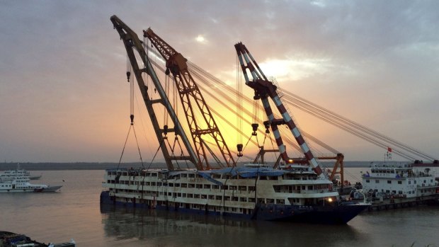 The capsized cruise ship Eastern Star is pulled out of the Yangtze river on Friday.