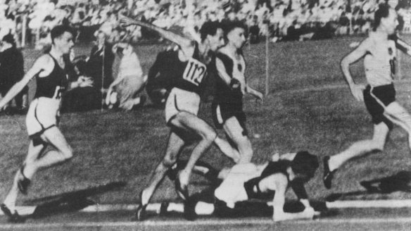 The moment in 1956: John Landy jumps over a fallen Ron Clarke at Olympic Park. He stopped to check that Clarke was OK.