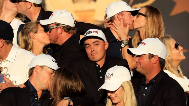 Not afraid to be different: Rickie Fowler looks on as a smoochfest breaks out at the Ryder Cup.