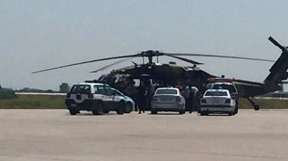Greek policemen check a Turkish Blackhawk helicopter after landing at the airport of Alexandroupolis, northeastern Greece, on Saturday.