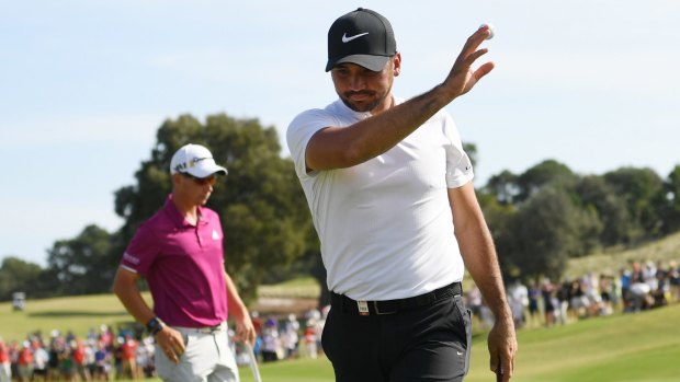 'It is what it is': Jason Day acknowledges the crowd as he walks off the 18th green to end a frustrating round.