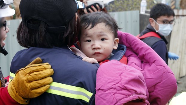 A baby boy is rescued from a collapsed building after the earthquake in Tainan.