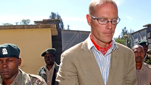 Thomas Patrick Gilbert Cholmondeley, right, grandson of the late Lord Delamare, is escorted to the Nakuru Court in Kenya in 2005. Murder charges were dropped against him after he killed a game warden.