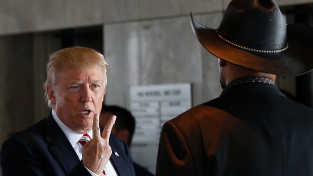 Republican presidential candidate Donald Trump gestures as he talks to Milwaukee County Sheriff David Clarke, Jr., as he visits the Milwaukee County War Memorial Center on a campaign stop in Milwaukee, Wisconsin.