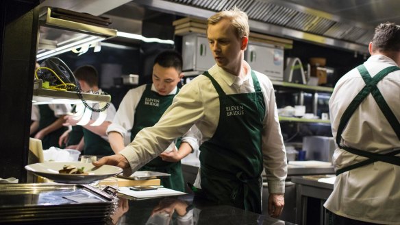 Chef Phil Wood works at the pass at Eleven Bridge in Sydney.