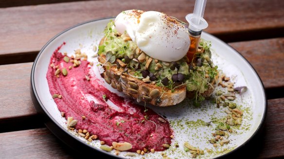 'Properly bashed' avocado with beetroot hummus and poached eggs.