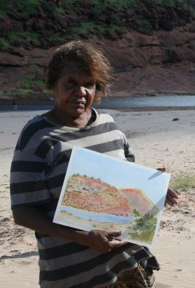 Lenie Namatjira with one of her paintings at Finke River.