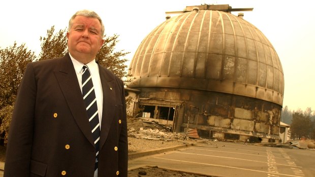 Then vice-chancellor of the ANU, Ian Chubb, stands beside the main 74inch telescope dome after the fires.