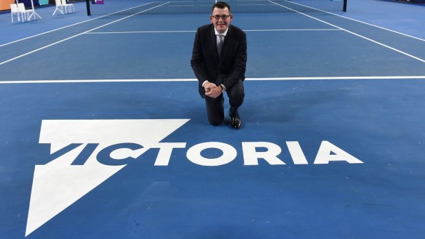 Victorian Premier Daniel Andrews poses with the new Victoria logo.