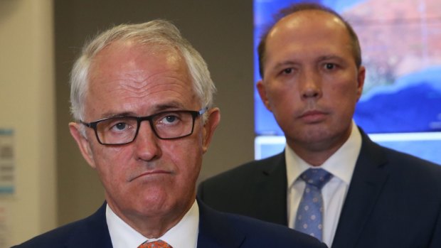 Prime Minister Malcolm Turnbull says Immigration Minister Peter Dutton (right) has suffered constant, often vicious attacks.