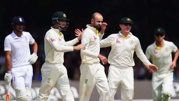 One of the 20:  Nathan Lyon celebrates with team-mates after taking the wicket of Jos Buttler at Lord's.