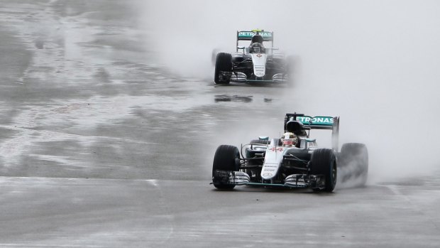 Mercedes driver Lewis Hamilton leads teammate Nico Rosberg in the rain during the British Formula One Grand Prix at the Silverstone on Sunday.