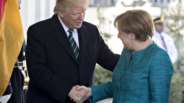 President Donald Trump greets Angela Merkel as she arrives at the West Wing of the White House.