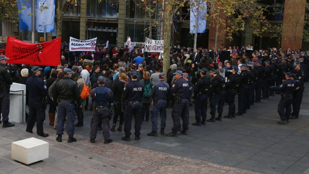Police watch on as a group stage a counter protest to the Reclaim Australia rally in Martin Place last July. 