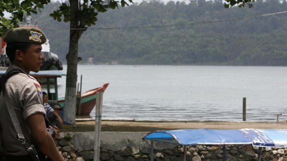 A policeman guards a harbour in Cilacap in Central Java near Nusakambangan prison island in 2008. 