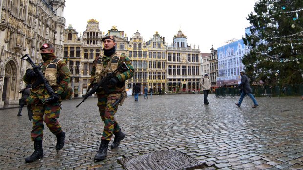 Armed soldiers patrol around the Grand Place in Brussels, Belgium.