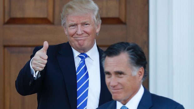 President-elect Donald Trump gives the thumbs-up as Mitt Romney leaves Trump National Golf Club in Bedminster, NJ.