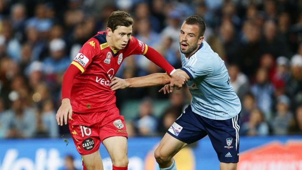 In action: Sydney's Mtt Jurman takes on Adelaide United midfielder Craiig Goodwin.