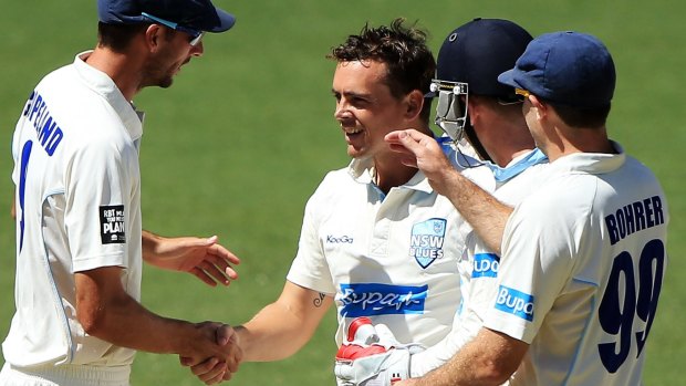 Still improving: O’Keefe is congratulated after taking a wicket for the Blues  last year.
