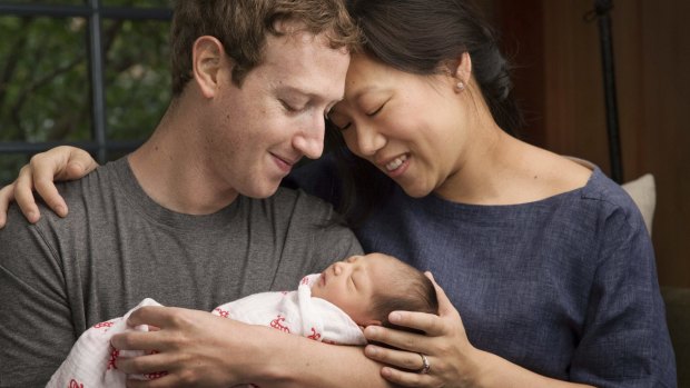 Max Chan Zuckerberg is held by her parents, Mark Zuckerberg and Priscilla Chan in a photo published to announce the birth of their daughter in December.