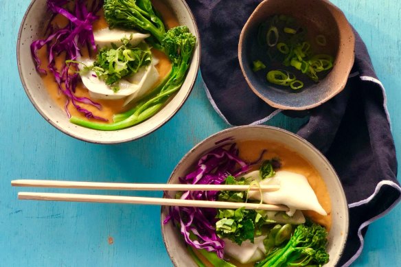 Dumplings swimming in quick red curry sweet potato soup.