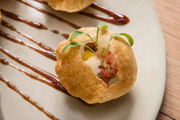 Pani puri - crisp semolina puff with sprouts, finger lime and mint water.
