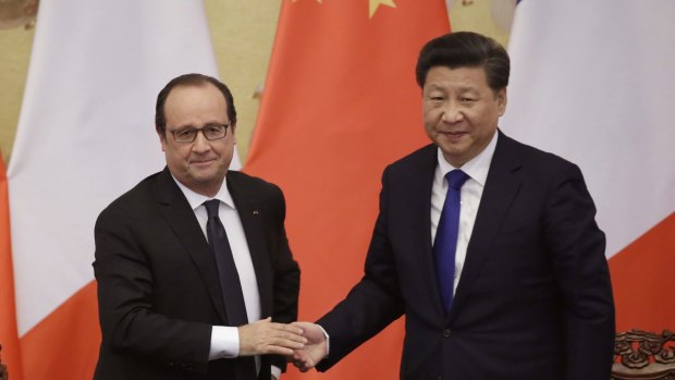 French President Francois Hollande, left, shakes hands with China's President Xi Jinping during a visit to Beijing.