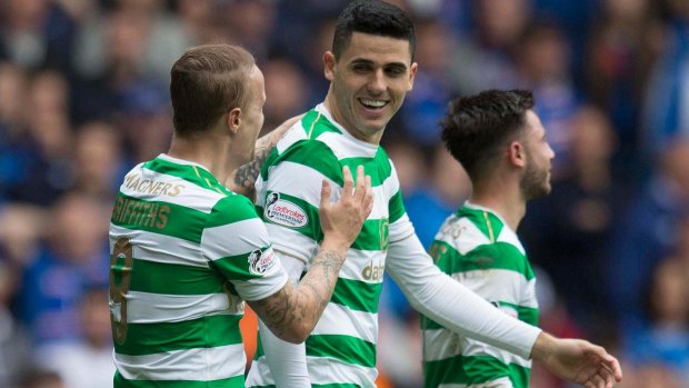 Bright beginning: Tom Rogic is congratulated after opening the scoring for Celtic, hammering a loose ball into the net, against Rangers at Ibrox Stadium.