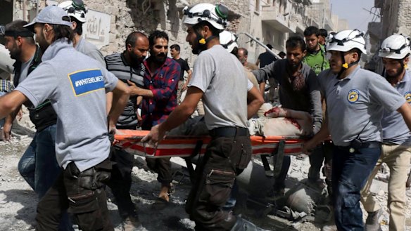 Emergency workers   in al-Sakhour, a  rebel-held part of eastern Aleppo.