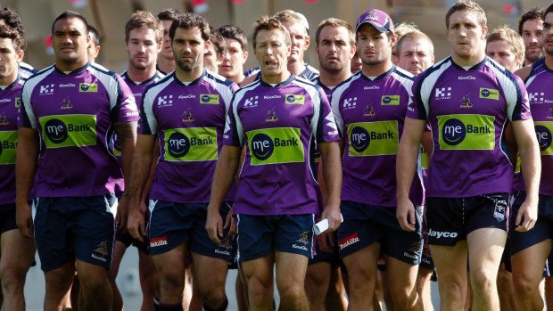 Storm players and coach Craig Bellamy make their defiant walk to waiting media after the scandal broke.