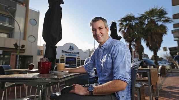 Craig Dick enjoys a coffee at a cafe in Elwood.