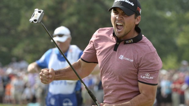 Three in a row: Jason Day celebrates after sinking a birdie putt on the 18th hole.
