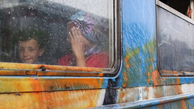 A migrant mother and child sit in a coach at a train station in Veles, central Macedonia, on their way north to the Serbian border.  