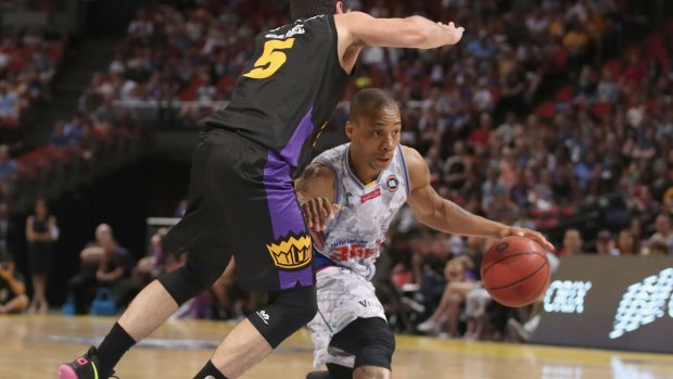 Finding a way through: Jerome Randle gets low to avoid Jason Cadee of the Kings.