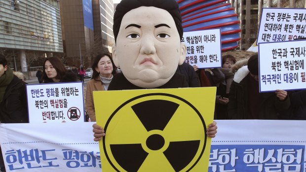 A South Korean university student wearing a mask depicting North Korean leader Kim Jong-un.