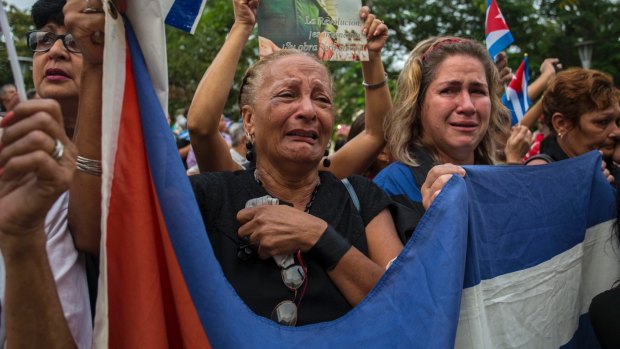 Women weep as the procession carrying the ashes of Fidel Castro leaves the town of Santa Clara on Thursday.