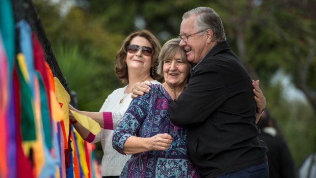 Carmel Rafferty (centre) gets a hug from child abuse survivor Kees Kortekaas while another survivor Noreen Wood looks on.