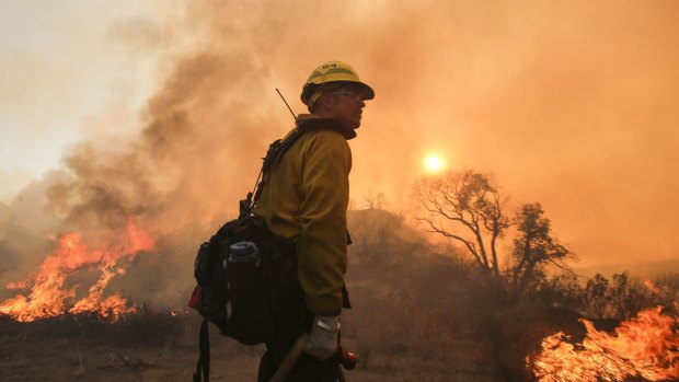 A firefighter watches a wildfire in Santa Clarita, California.